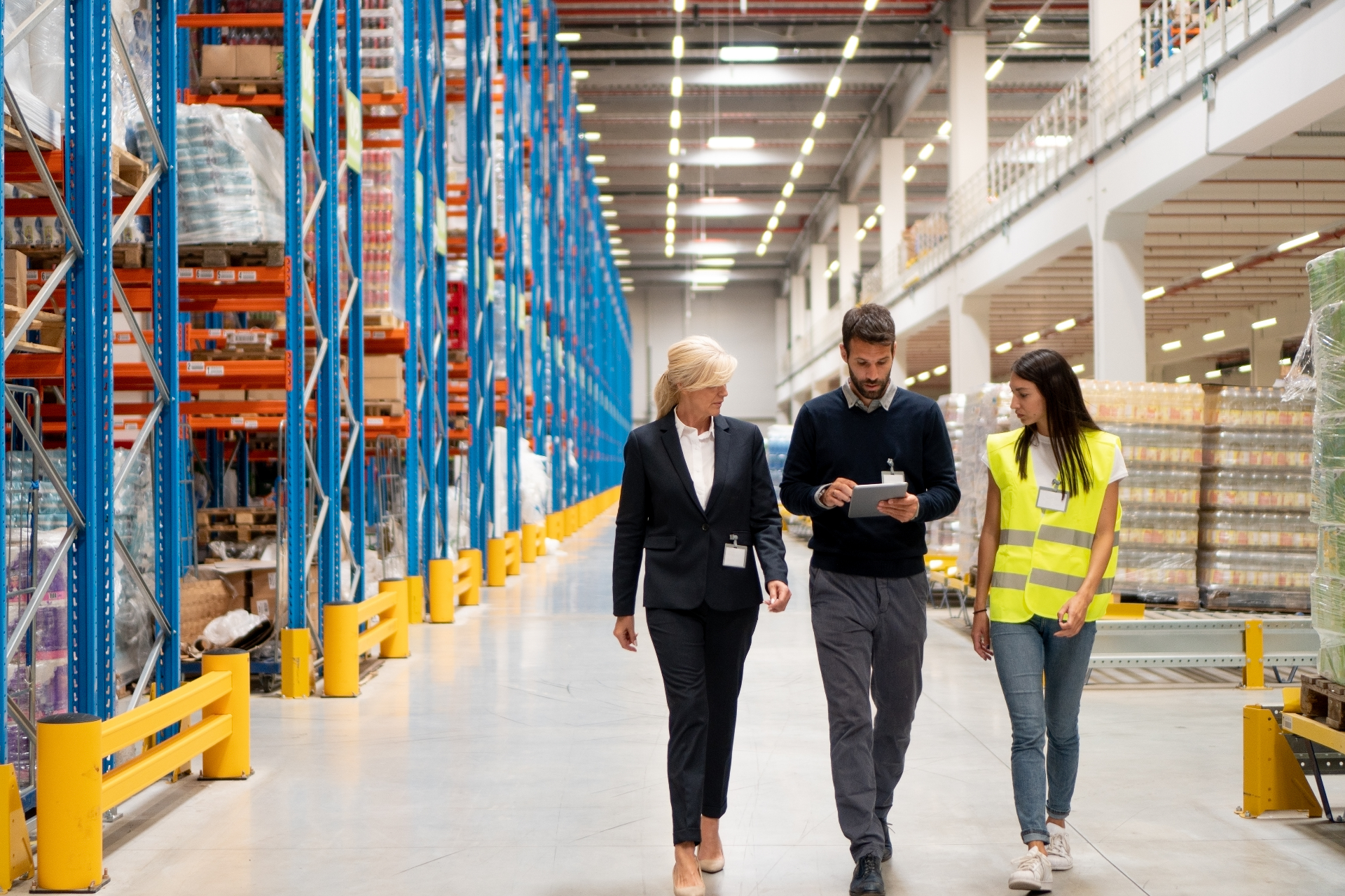 Operations leaders walking a distribution centre with an internal auditor